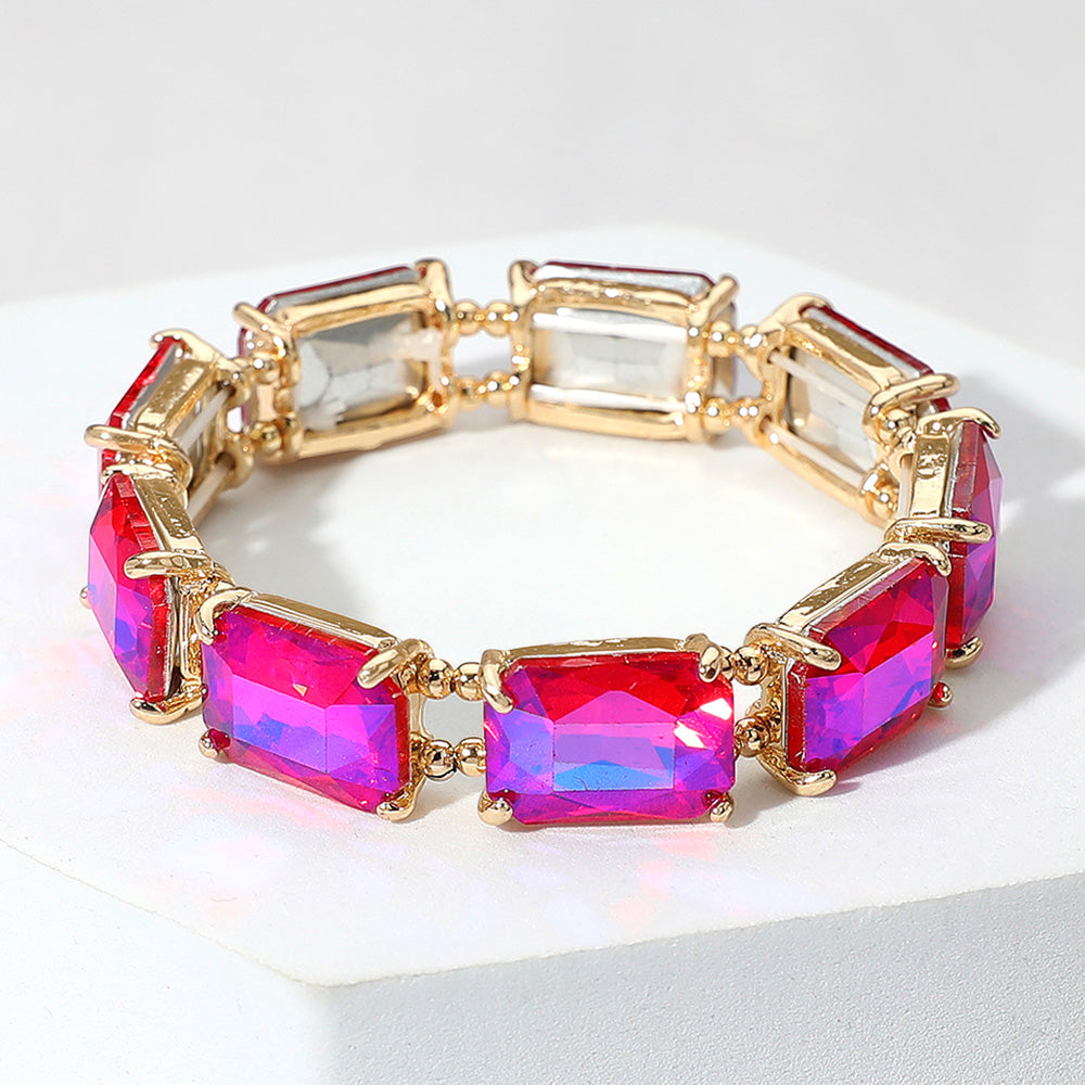 Bracelet with gold frame and Fuchsia gemstones on a white background