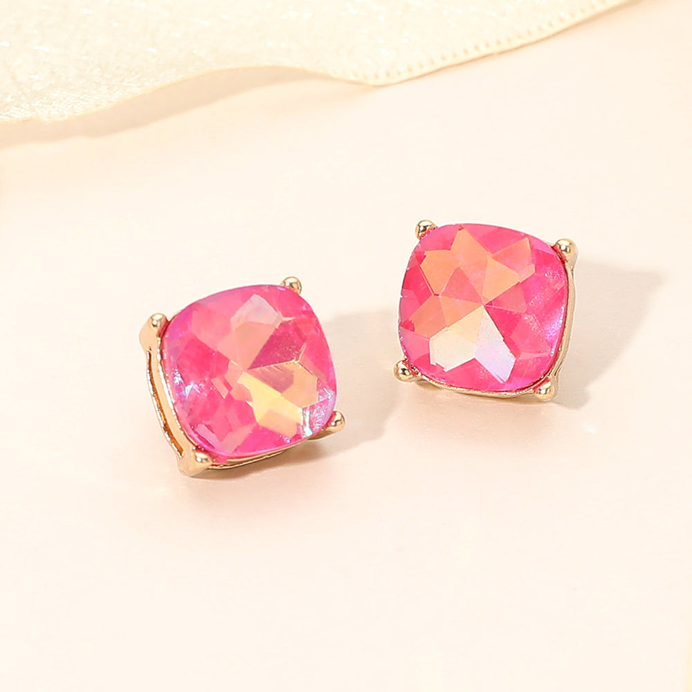 Fuchsia AB square cushion stud earrings on gold on light beige background