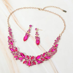 Fuchsia Hot Pink marquise stone cluster prom and evening necklace set on gold on white marble background