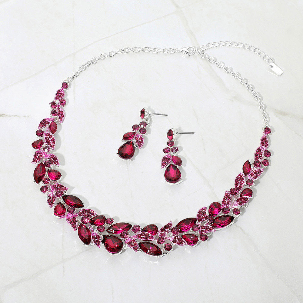 Fuchsia Hot Pink marquise and teardrop crystal cluster formal necklace set on silver with matching earrings on white marble background