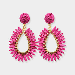 Fuchsia-hot pink woven raffia open teardrop earrings on gold with post backs isolated on a white background.