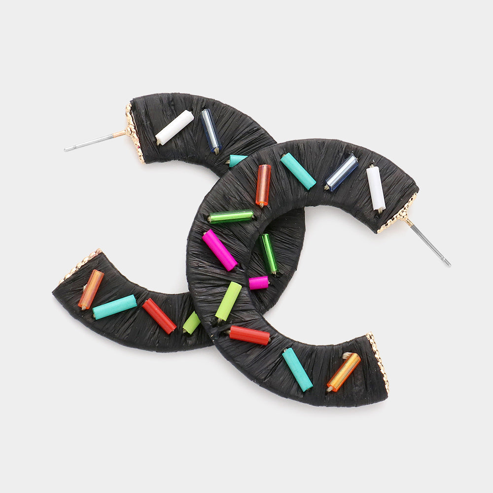 Multi Color Cylinders embellished onto a black raffia wrapped half earring on a white background 1.75"
