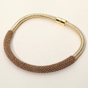 Gold Stone crystal beaded magnetic choker necklace on gold with a textured crystal-beaded front section, displayed on a light beige background.