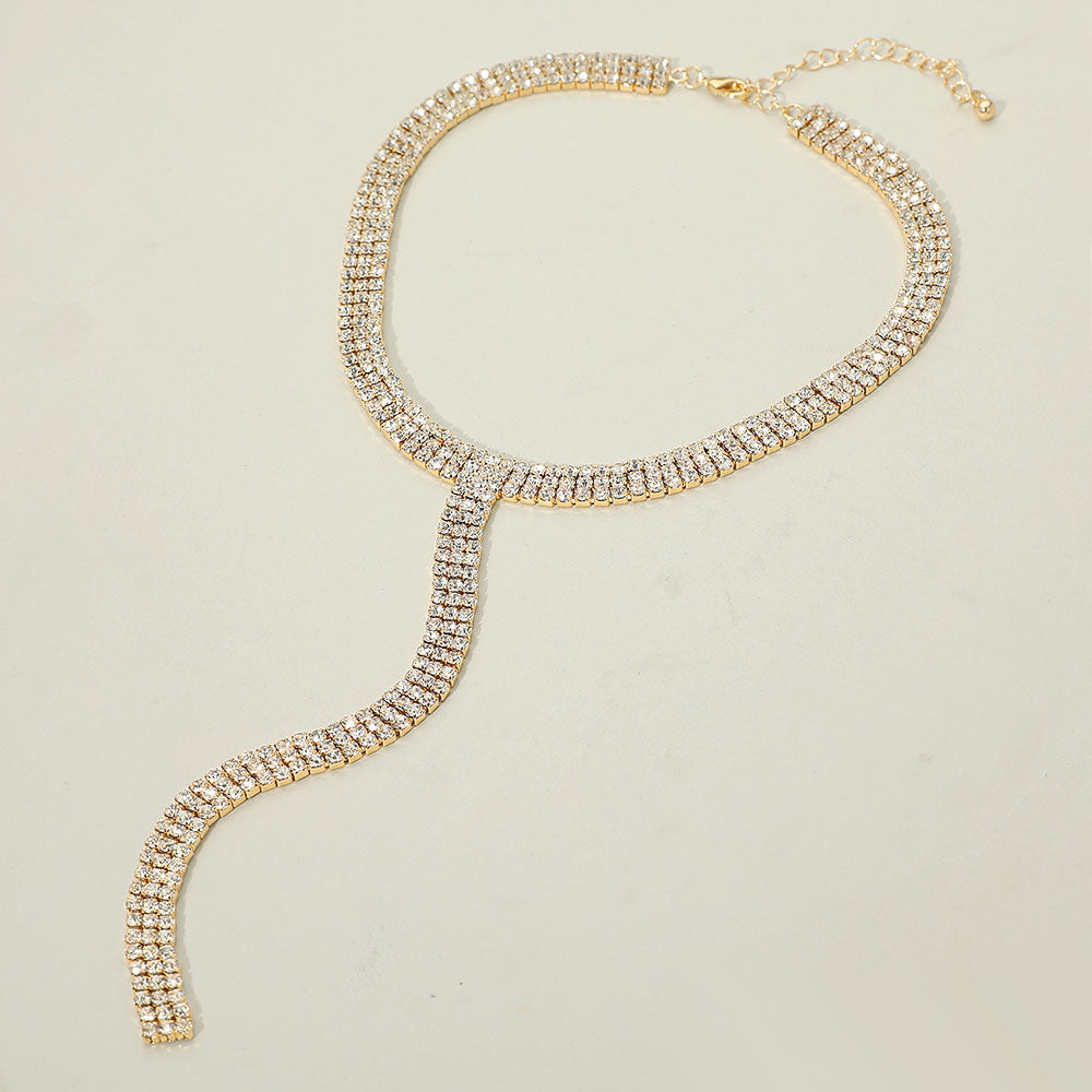 Gold dipped Y-shaped rhinestone necklace with 3-line design and long drop pendant for formal wear on a white background