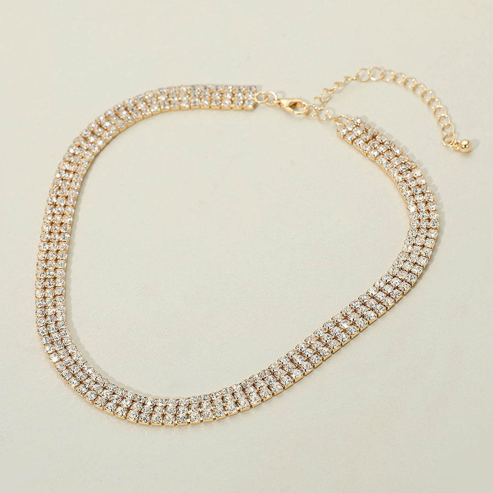Gold triple row rhinestone necklace with slim crystal strands for weddings or prom. picture is on a white background