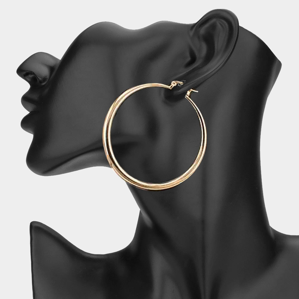 Gold 2.5-inch hoop earring with pin catch clasp, displayed on a black mannequin ear.