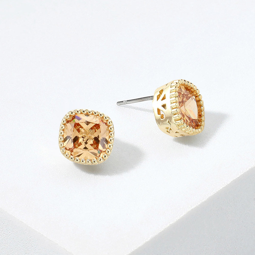 Peach square CZ stud earrings on gold displayed on white background