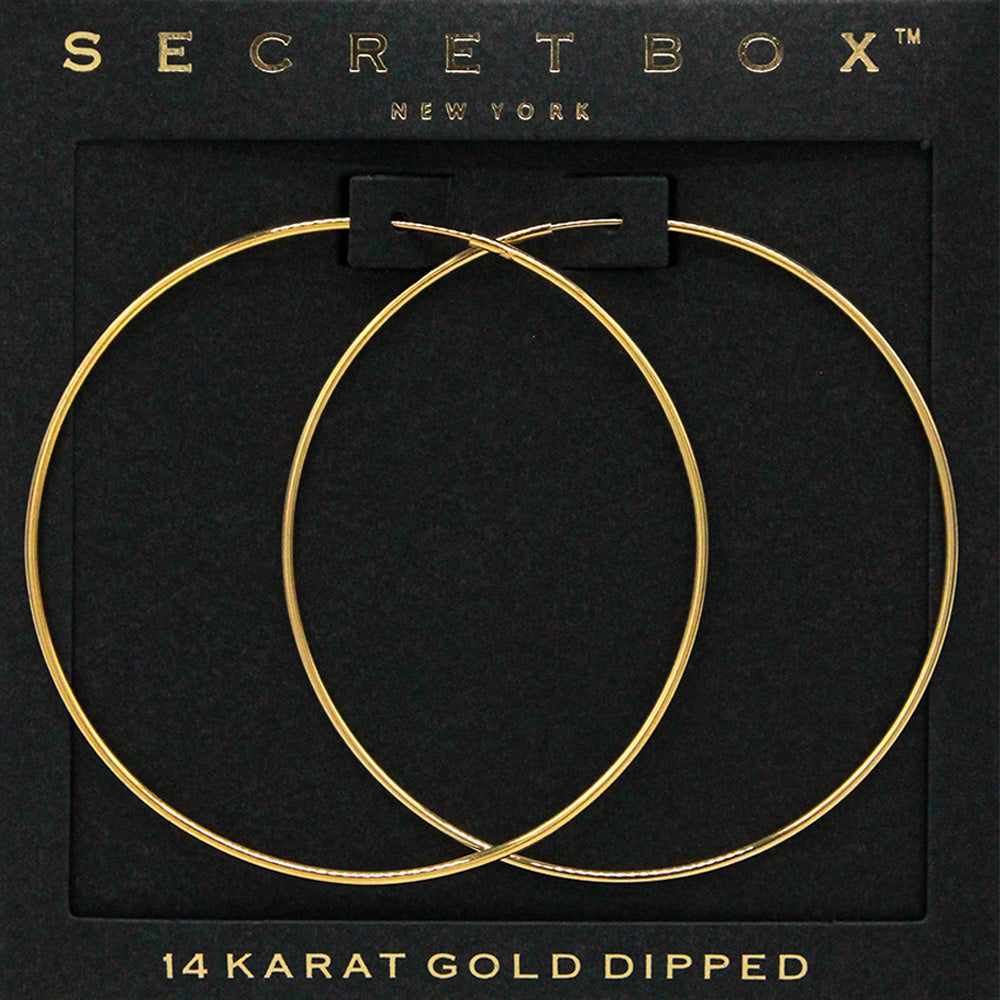 Gold wire hoop earrings with a 2.25-inch diameter displayed on a black jewelry card.