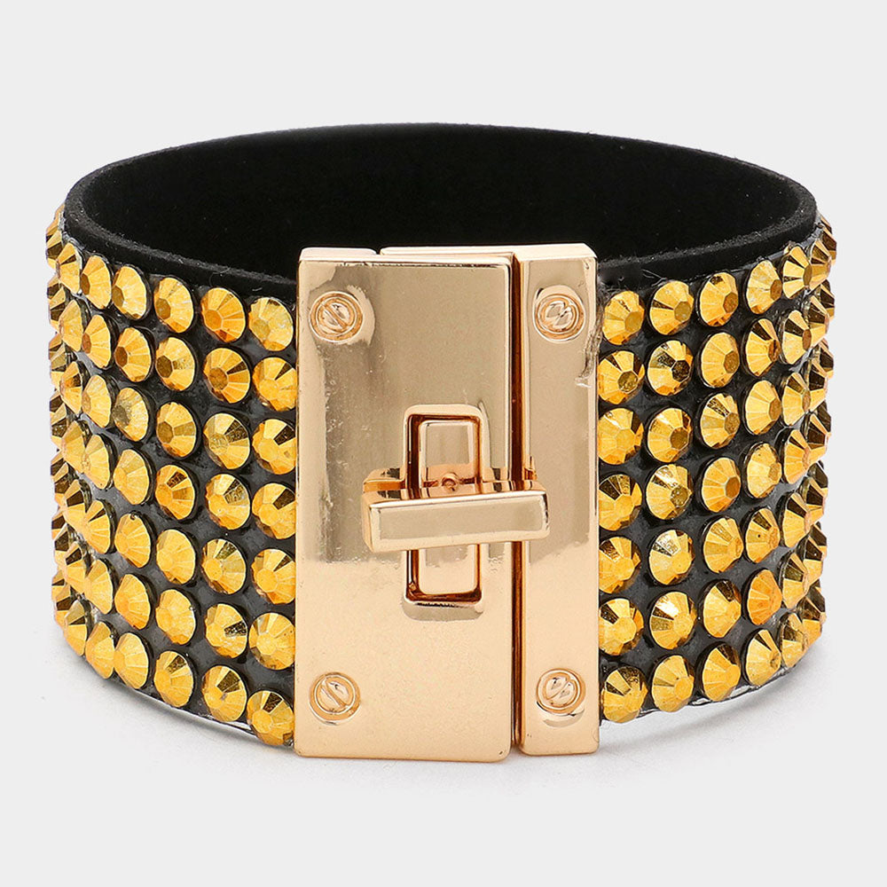Gold on black 7-row rhinestone bling studded bracelet with gold hardware on a white background