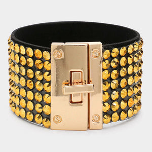 Gold on black 7-row rhinestone bling studded bracelet with gold hardware on a white background