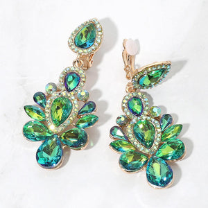 Gold-tone chandelier clip-on earrings with green AB teardrop and oval faceted crystals surrounded by smaller rhinestones on a white background.