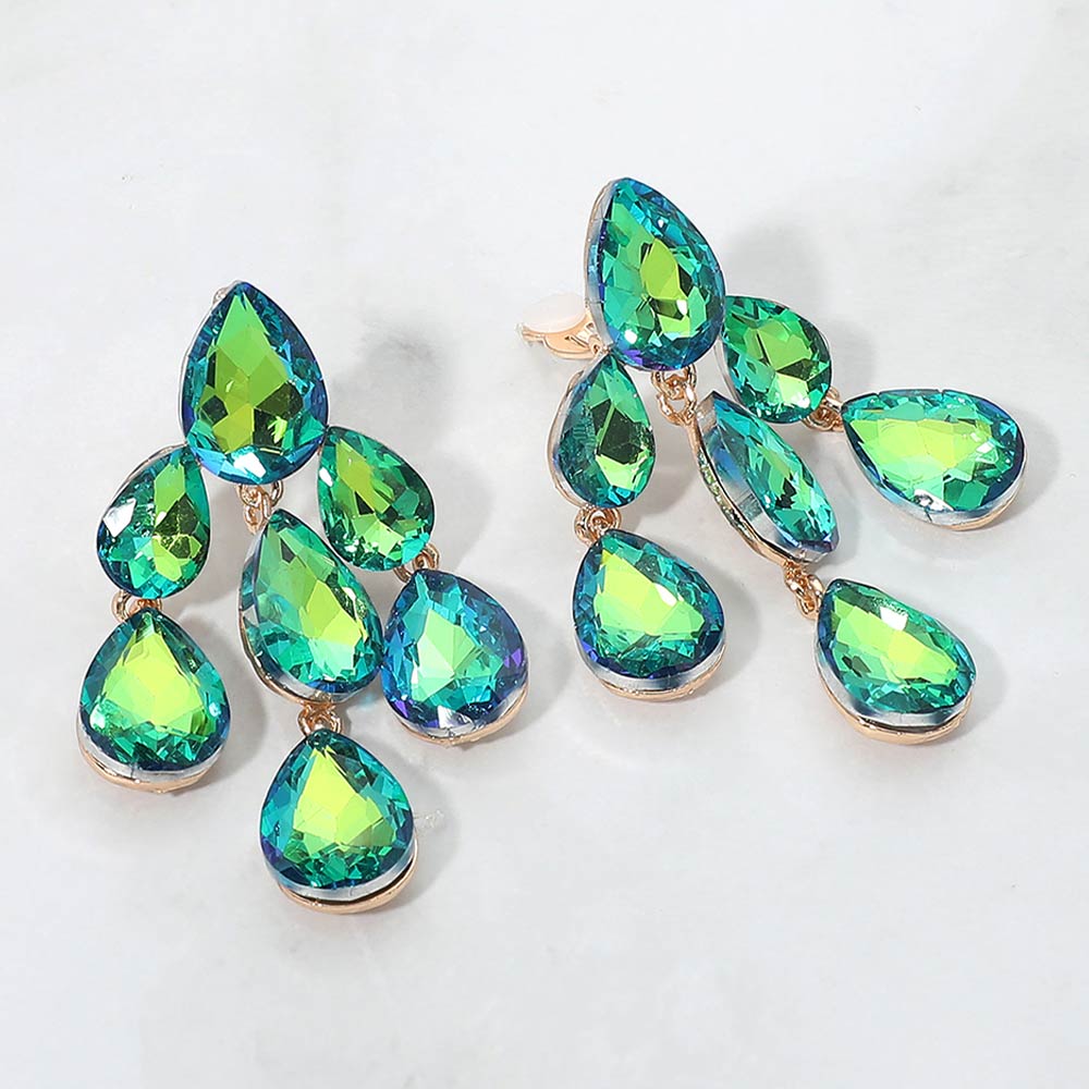 Green AB crystal teardrop cluster chandelier clip-on earrings on gold with iridescent stones on white marble background
