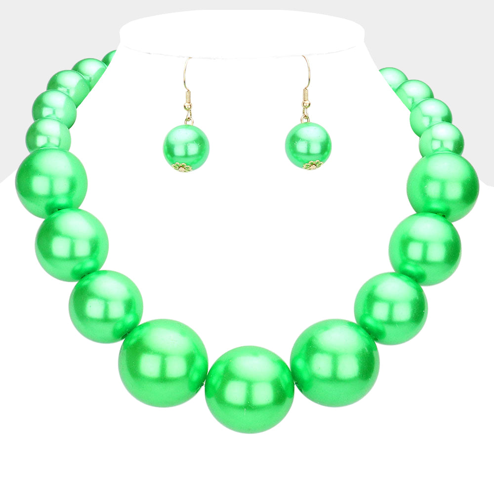 Green Oversized Graduated Pearl Glossy Statement Necklace Set on gold on a white background.