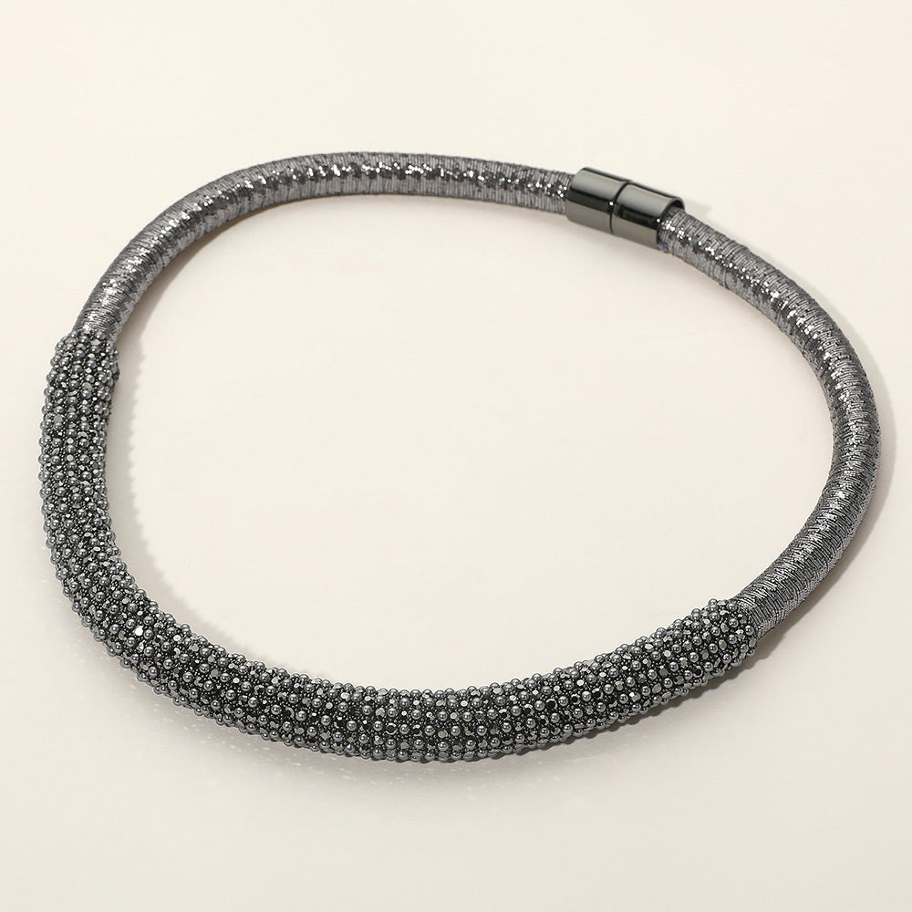 Smoky Gray crystal beaded magnetic choker necklace with a textured crystal-beaded front section, displayed on a light beige background.