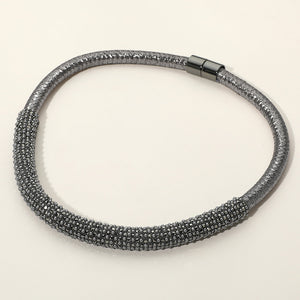 Smoky Gray crystal beaded magnetic choker necklace with a textured crystal-beaded front section, displayed on a light beige background.
