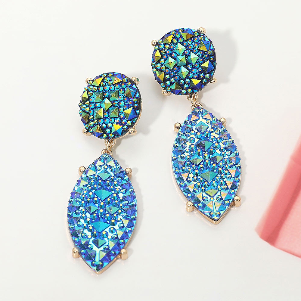 Iridescent sapphire royal blue and AB rhinestone marquise drop pageant earrings on gold on a white background