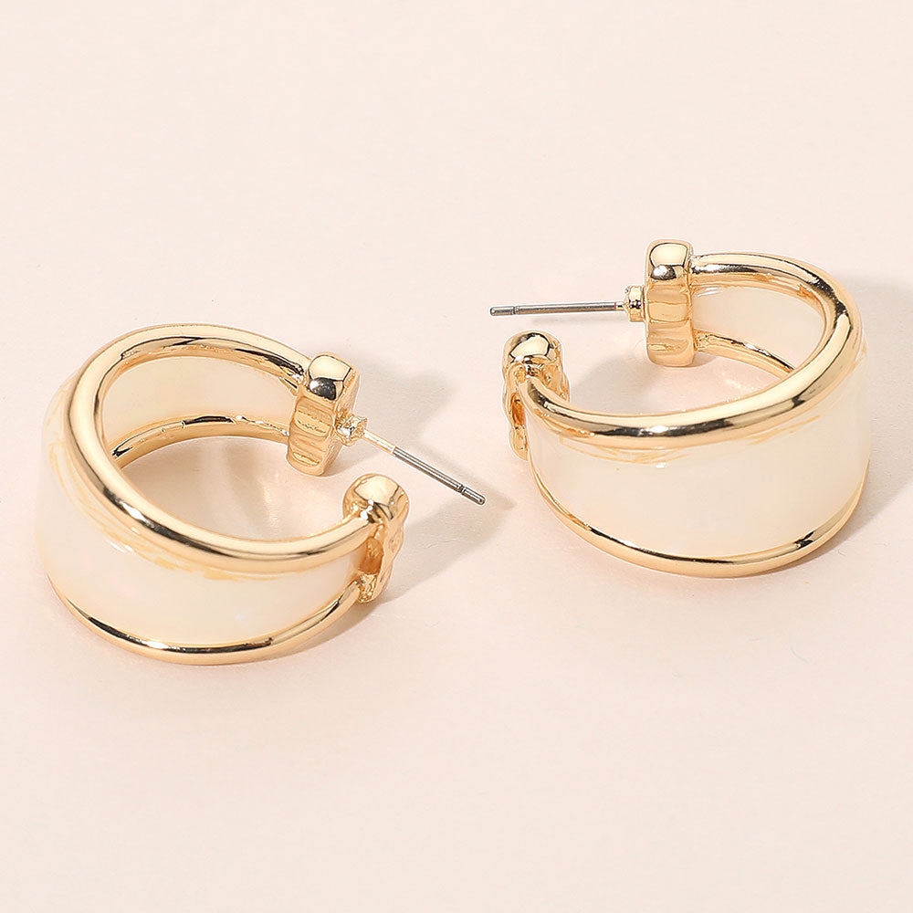 Ivory marbled resin half hoop earrings with wide chunky statement design trimmed in gold for fun fashion and everyday wear on a light beige background