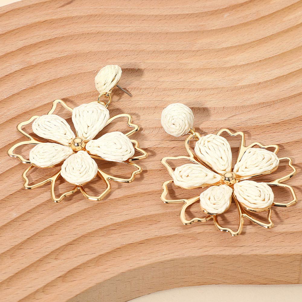 Ivory raffia floral dangle earrings with layered petal design and boho statement style. Fun fashion earrings for runway, appearances, and standout looks.