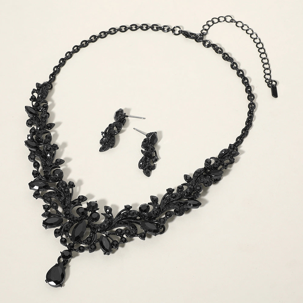 Jet black stone cluster prom necklace set with matching earrings on a cream background