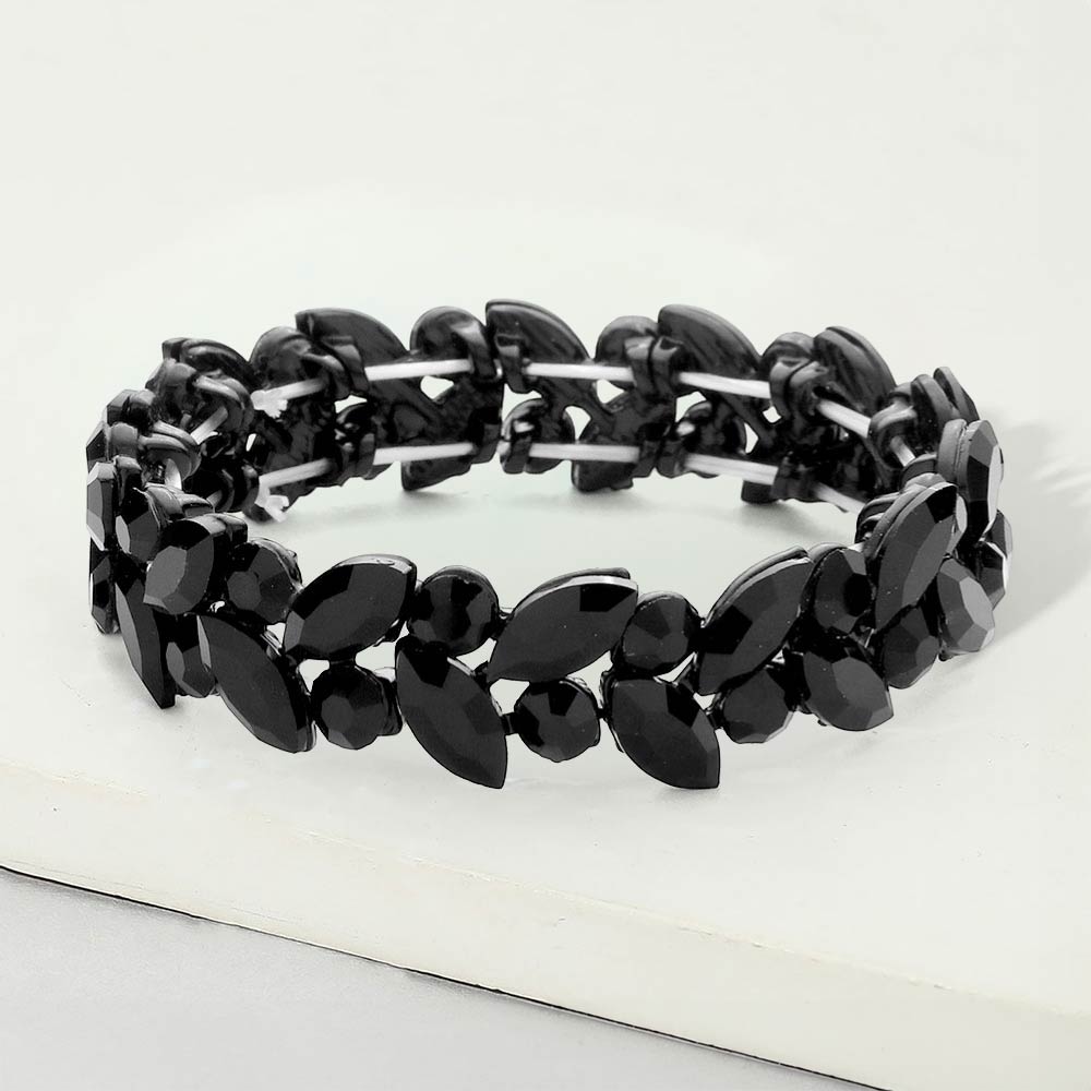 Jet black marquise and round stone cluster stretch bracelet on black on a white marble background