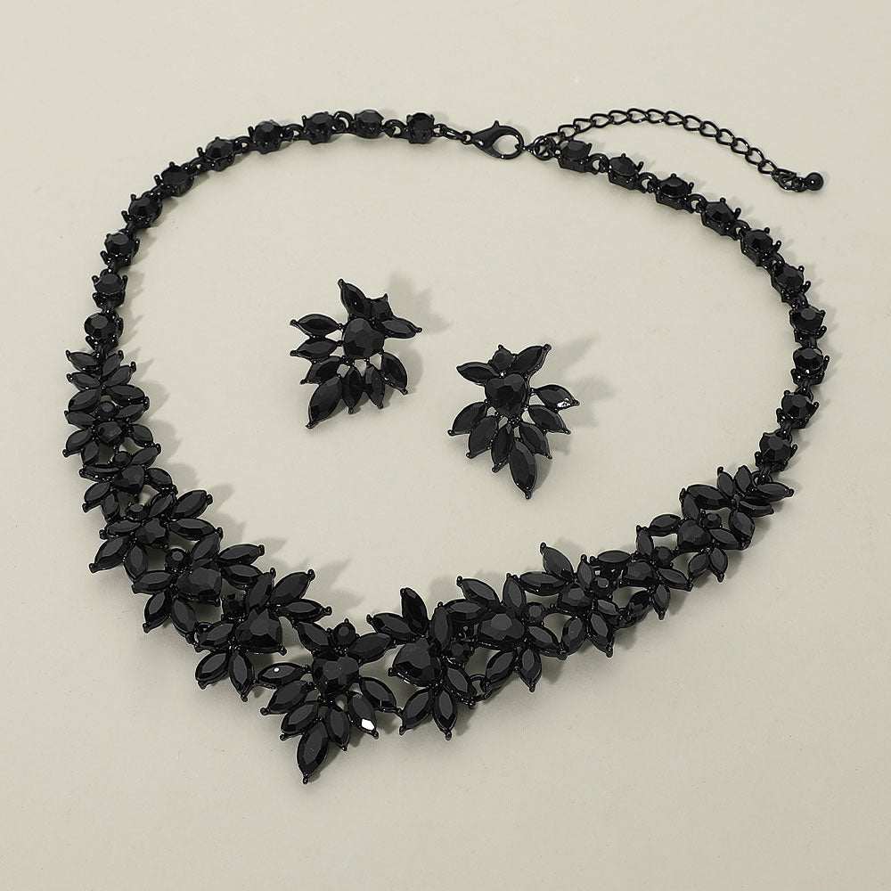 Jet black marquise floral statement necklace set on black on a beige background
