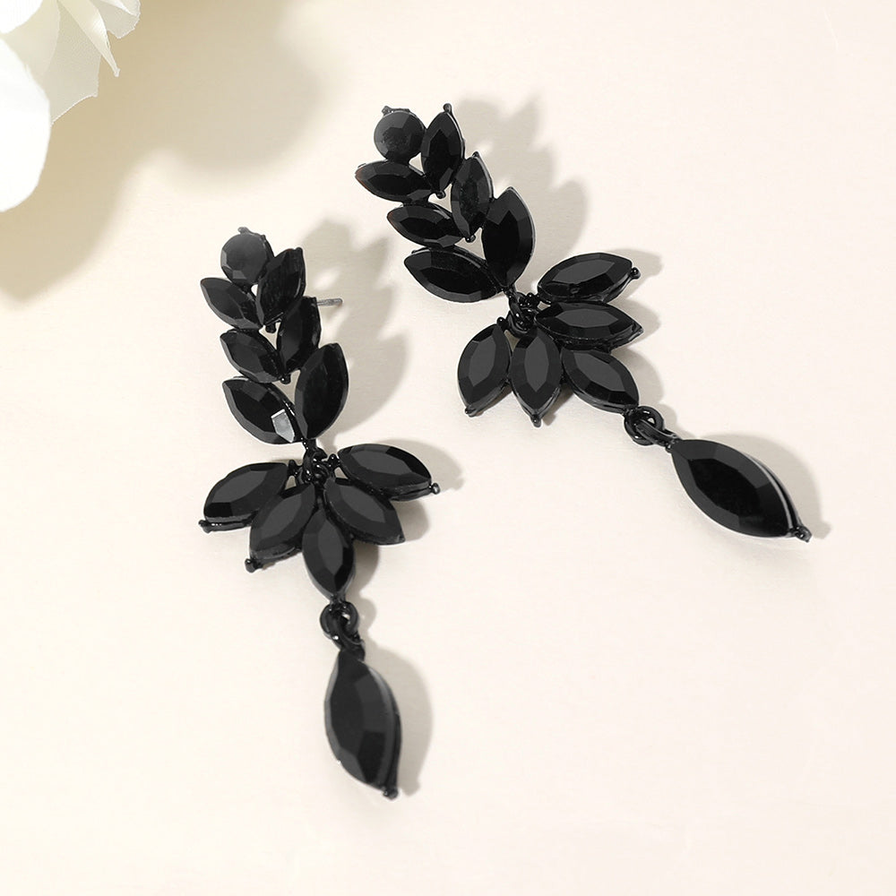 Jet black marquise stone cluster leaf drop earrings on black with elegant dangling accent, 2.5 inch statement earrings on a light beige background