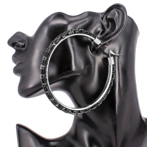 Jet black oversized baguette rhinestone hoop earrings on silver with omega back on black mannequin ear
