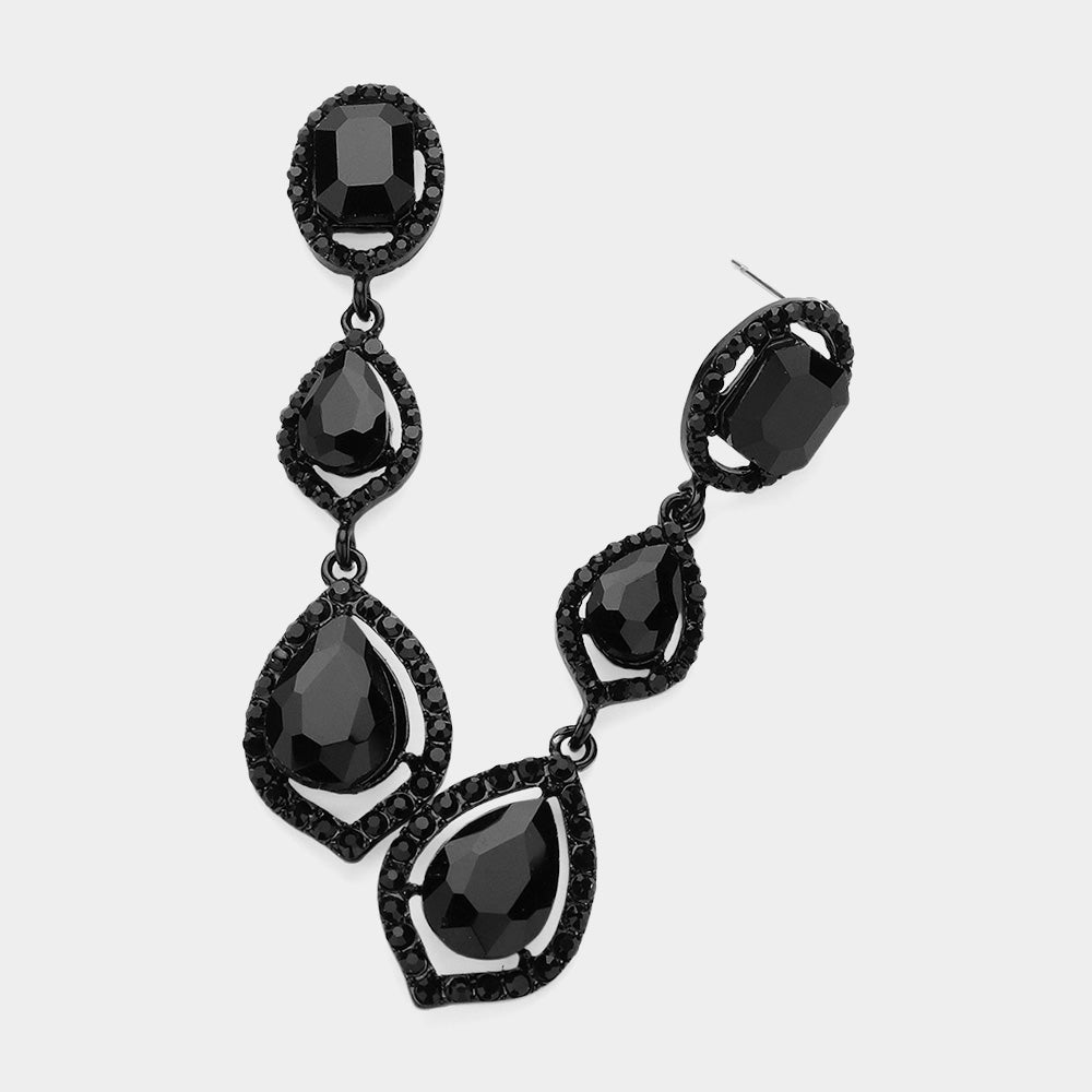 Pair of black-tone drop earrings featuring large jet black oval and pear-shaped crystals surrounded by small clear stones on a light gray background.