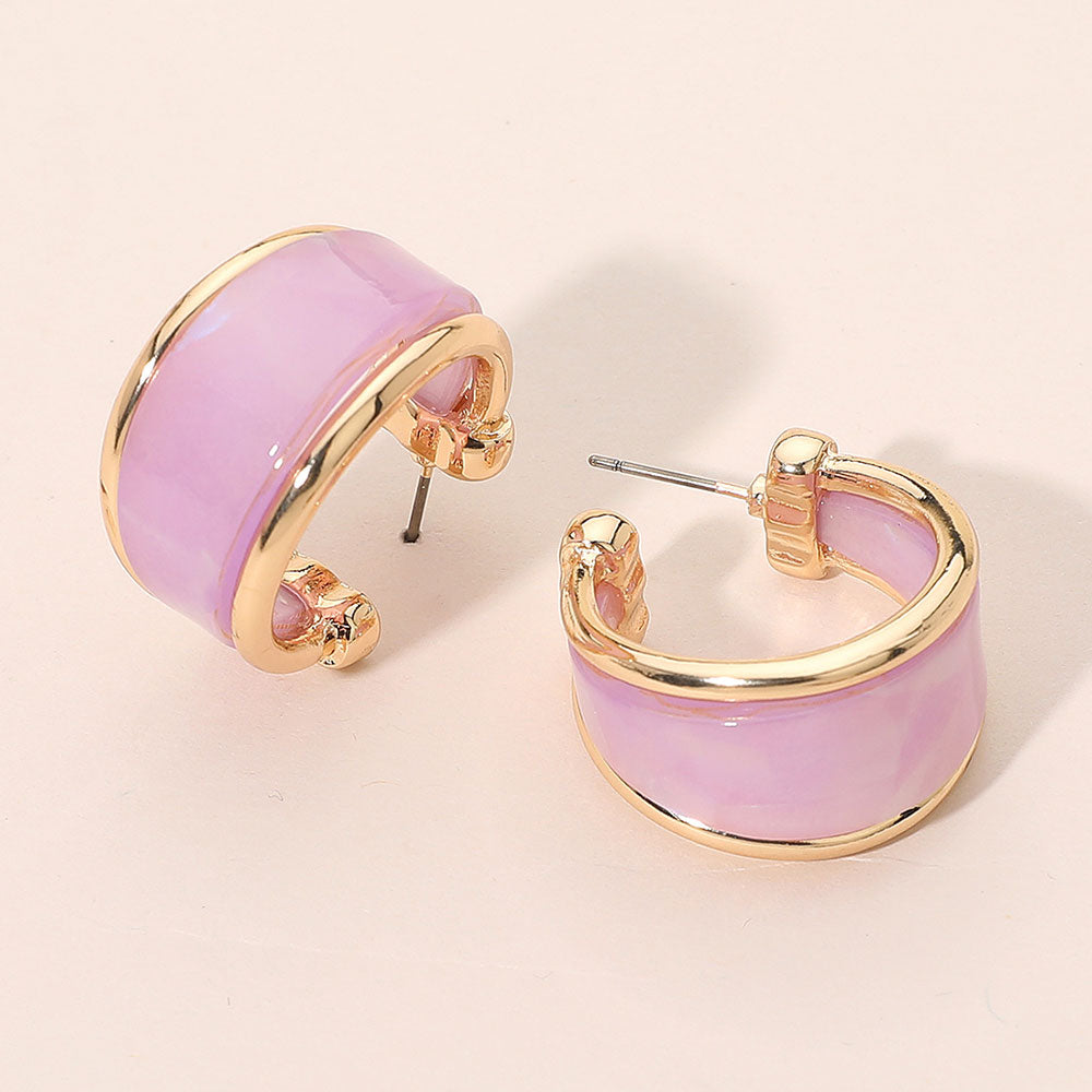 Lavender marbled resin half hoop earrings with wide chunky statement design trimmed in gold for fun fashion and everyday wear on a light beige background