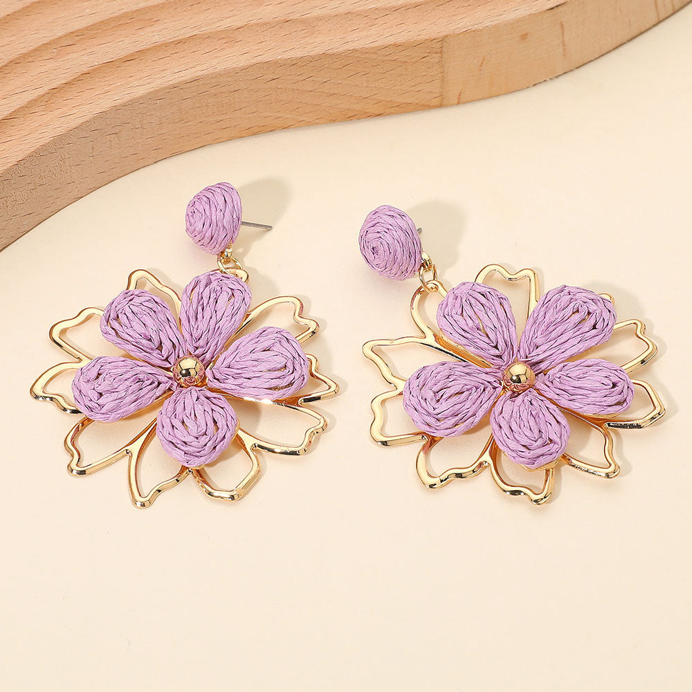 Lavender raffia floral dangle earrings with layered petal design and boho statement style. Fun fashion earrings for runway, appearances, and standout looks.