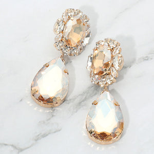Champagne-Gold Stone oval and teardrop earrings with clear crystal accents on gold on a white marble background