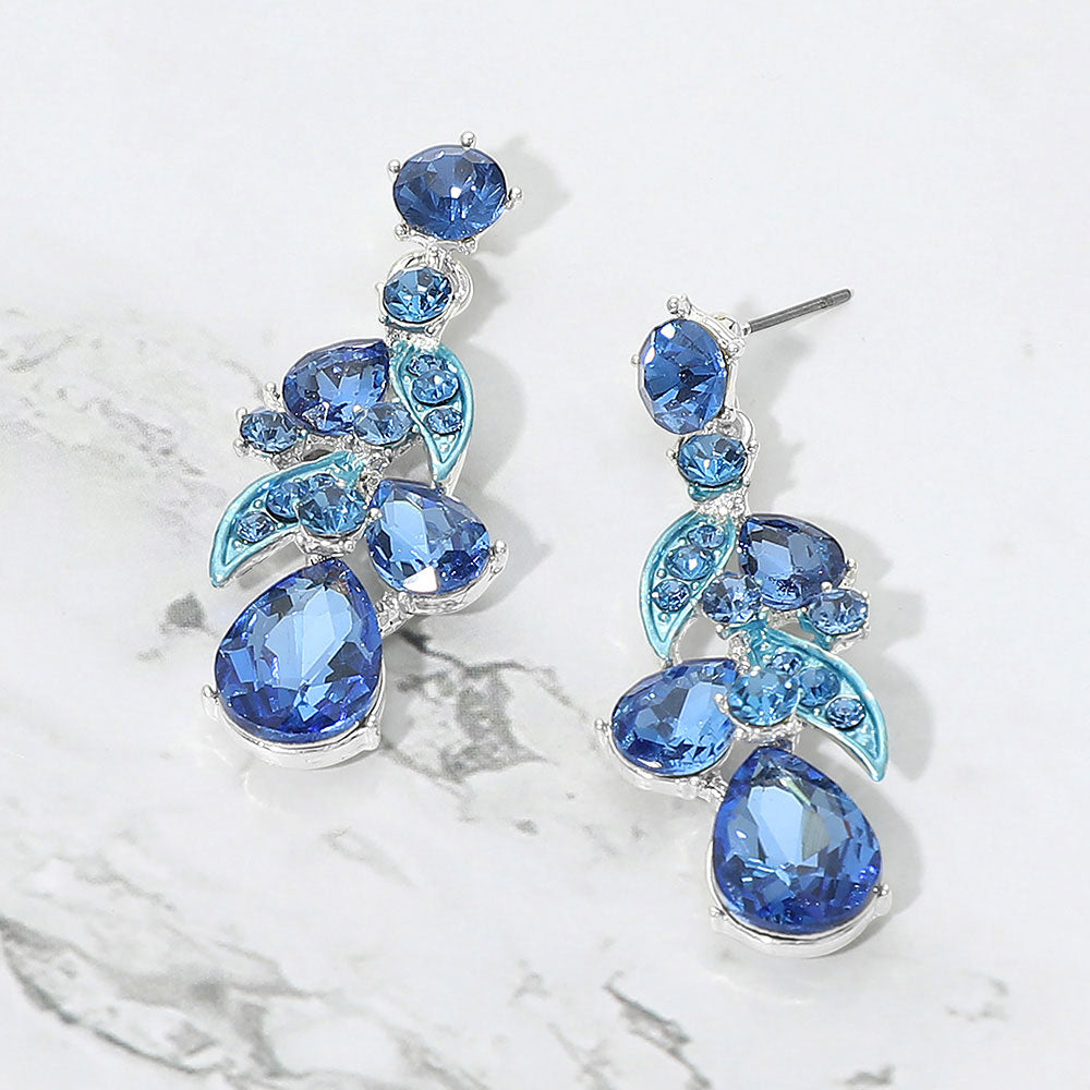 Light blue teardrop crystal cluster drop prom and formal earrings on silver on white marble background