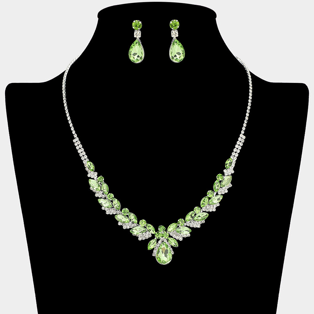 Light green teardrop marquise prom necklace set on silver with matching earrings displayed on a black mannequin bust on a white background.