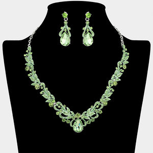Light green teardrop leaf crystal statement necklace set with matching earrings in a silver setting, shown on a black mannequin bust on a white background