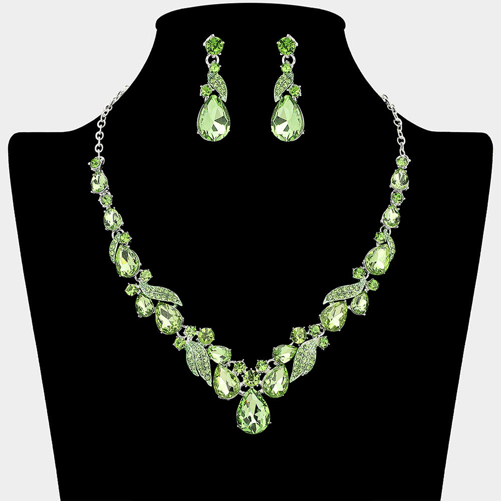 Light green teardrop leaf prom necklace set on silver with matching earrings displayed on a black mannequin bust on a white background.