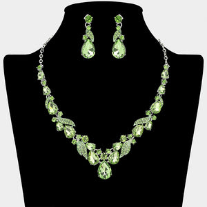 Light green teardrop leaf prom necklace set on silver with matching earrings displayed on a black mannequin bust on a white background.