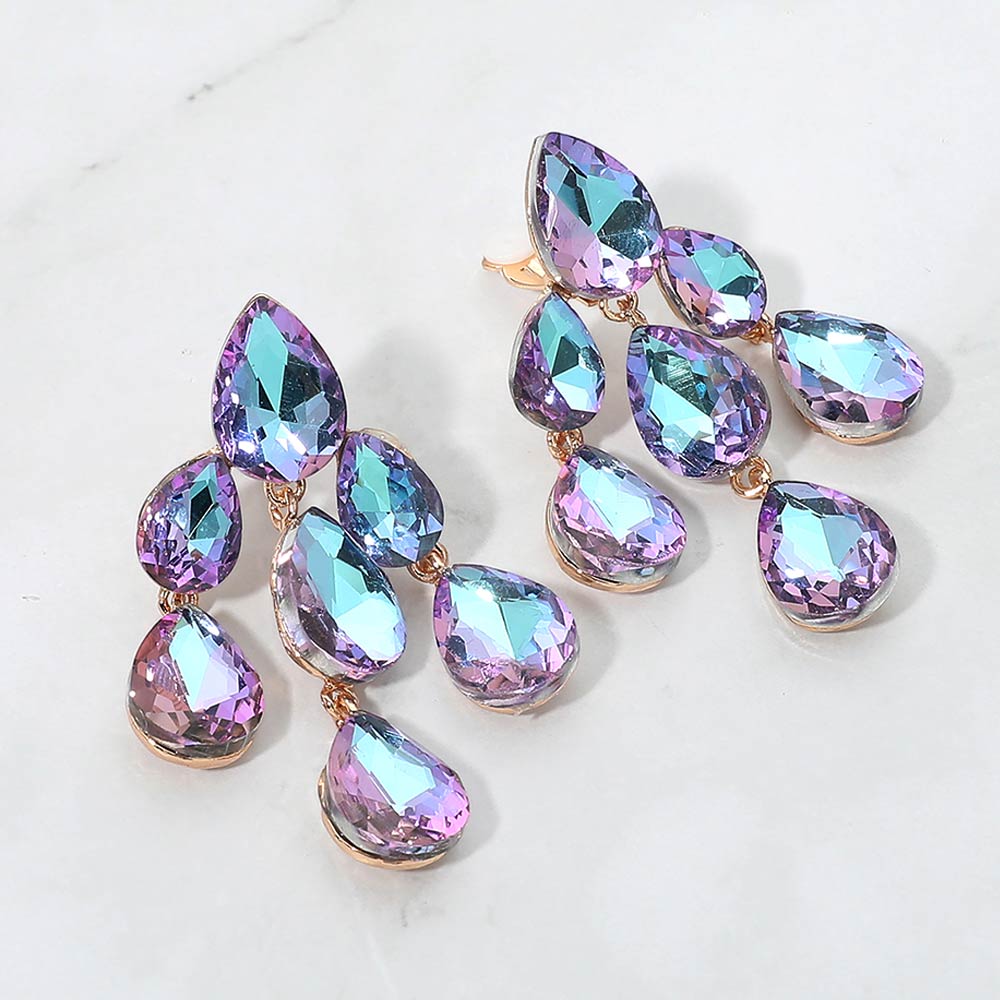 Multi-color iridescent crystal teardrop cluster chandelier clip-on earrings on gold on white marble background