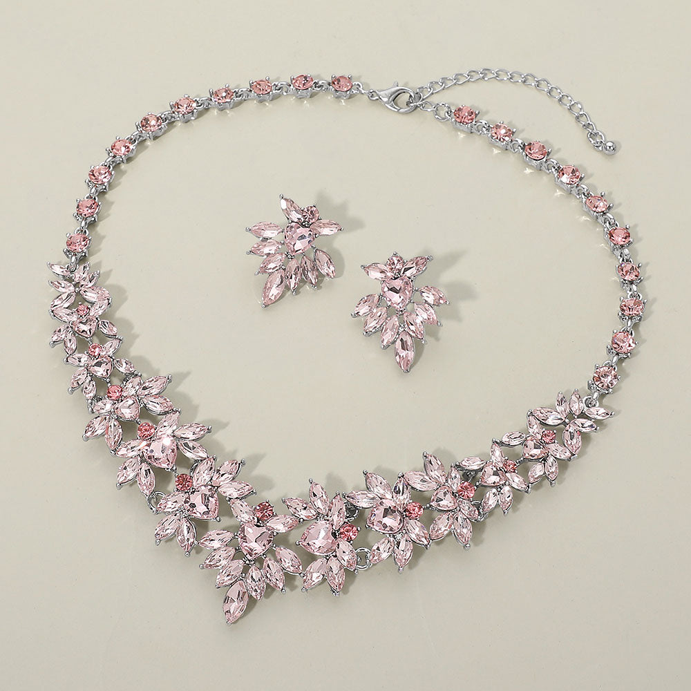 Light pink marquise floral statement necklace set on silver on a beige background