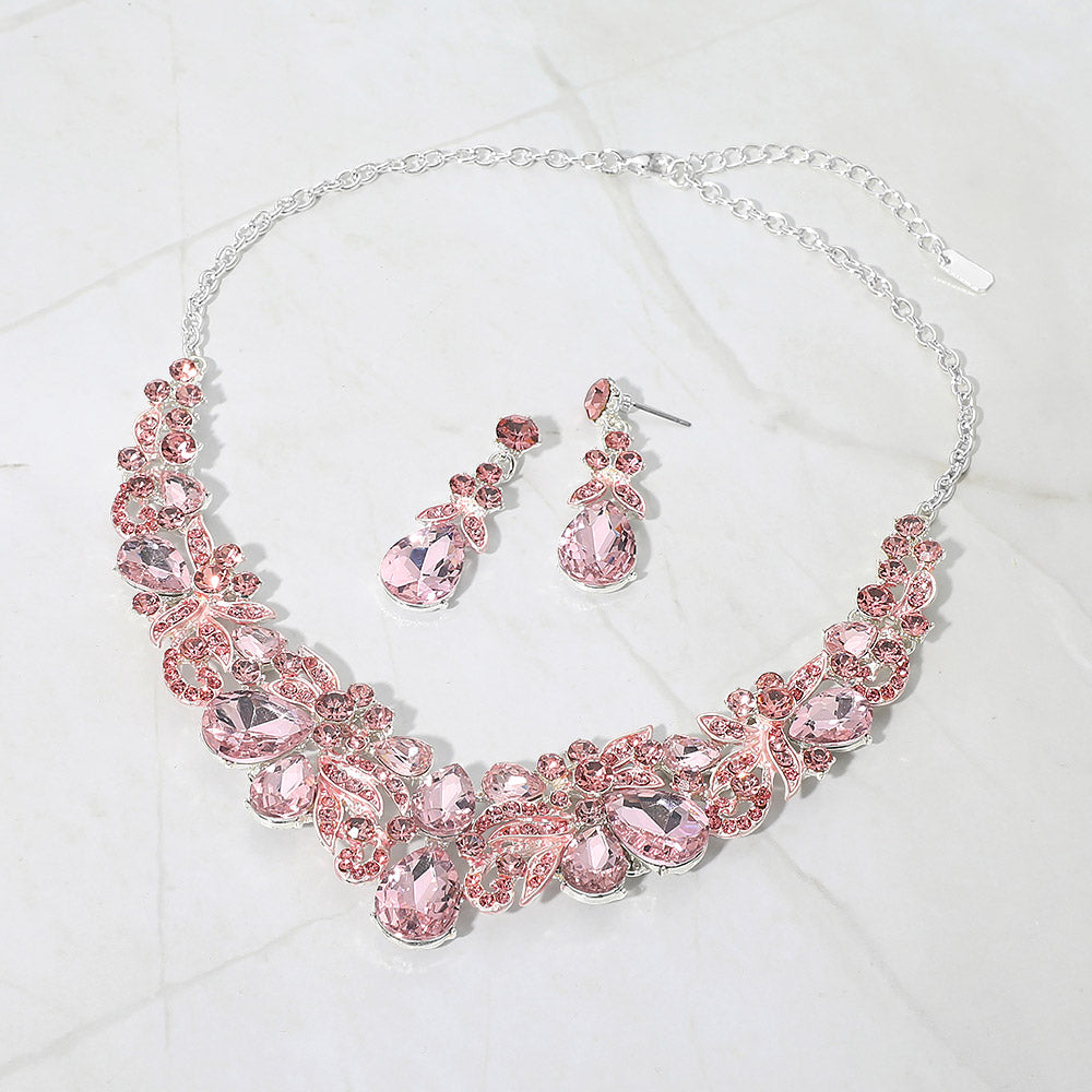 Light pink teardrop floral statement necklace set on silver displayed on white background