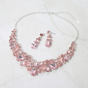 Light pink teardrop floral statement necklace set on silver displayed on white background