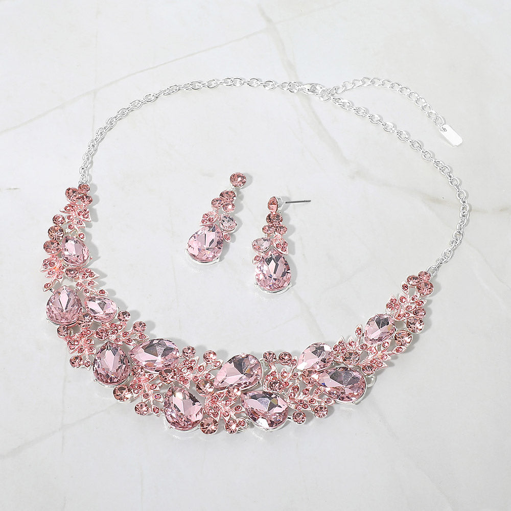 Light pink teardrop leaf branch statement necklace set on silver on a white marble background