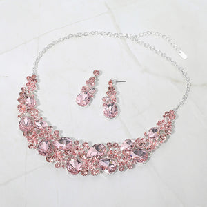 Light pink teardrop leaf branch statement necklace set on silver on a white marble background