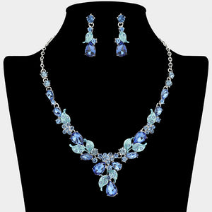 Light sapphire teardrop leaf necklace set on silver with matching earrings for prom and evening wear on a black mannequin bust on a white background.