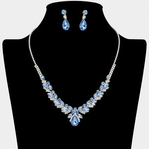 Sapphire blue teardrop marquise prom necklace set on silver with matching earrings displayed on a black mannequin bust on a white background.