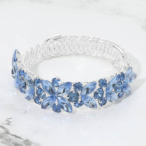 Light sapphire marquise floral crystal bracelet on silver with adjustable fit, elegant blue statement jewelry for prom and evening wear on a marble background