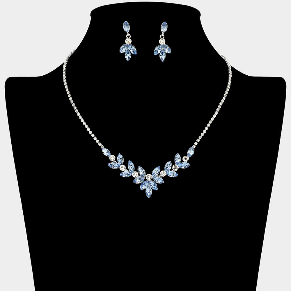 Light sapphire marquise leaf necklace set on silver with matching earrings for prom and evening wear on a black mannequin bust on a white background.