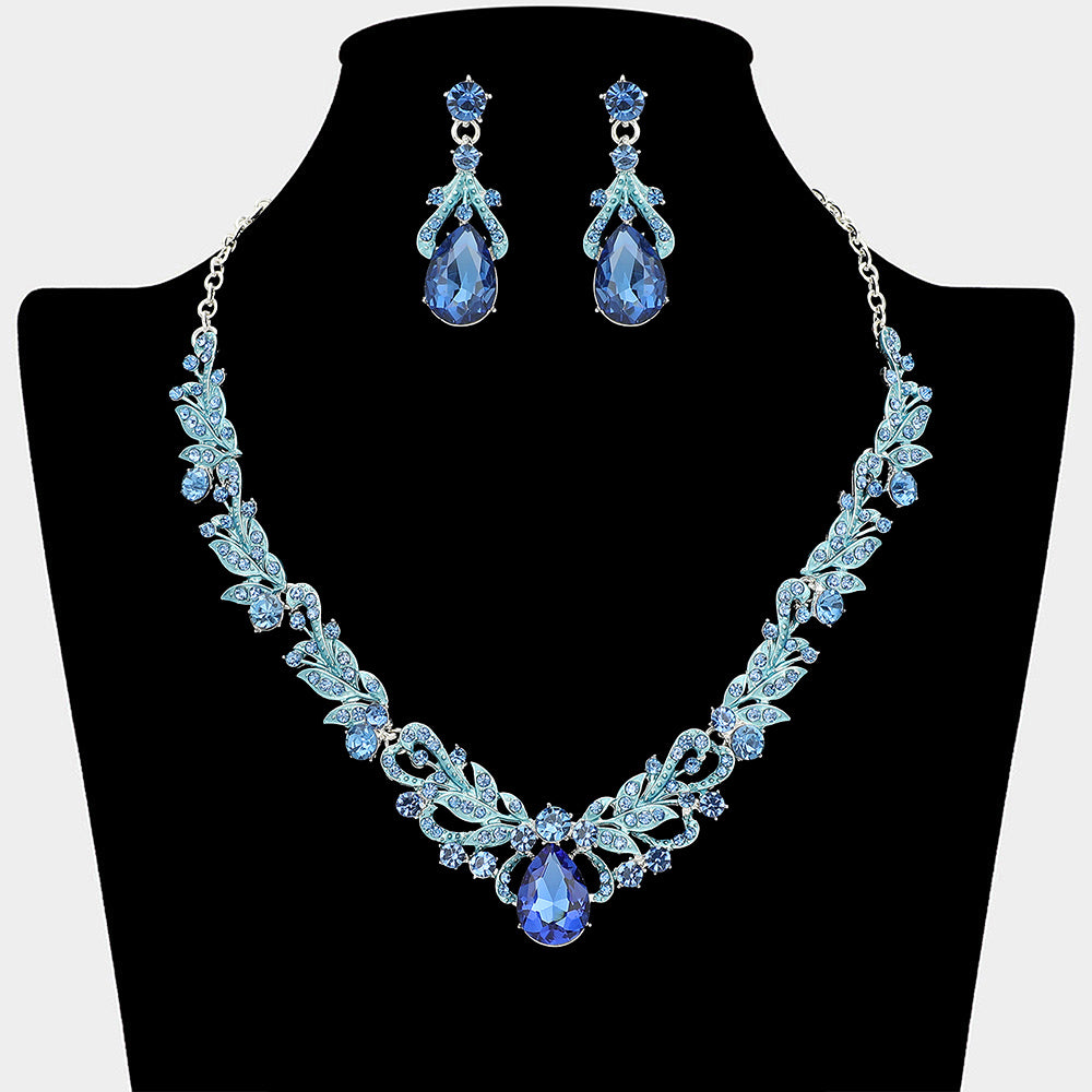 Light sapphire teardrop leaf crystal statement necklace set with matching earrings in a silver setting, shown on a black mannequin bust on a white background