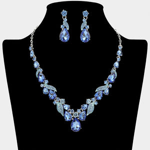 Light sapphire blue teardrop leaf prom necklace set on silver with matching earrings displayed on a black mannequin bust on a white background.