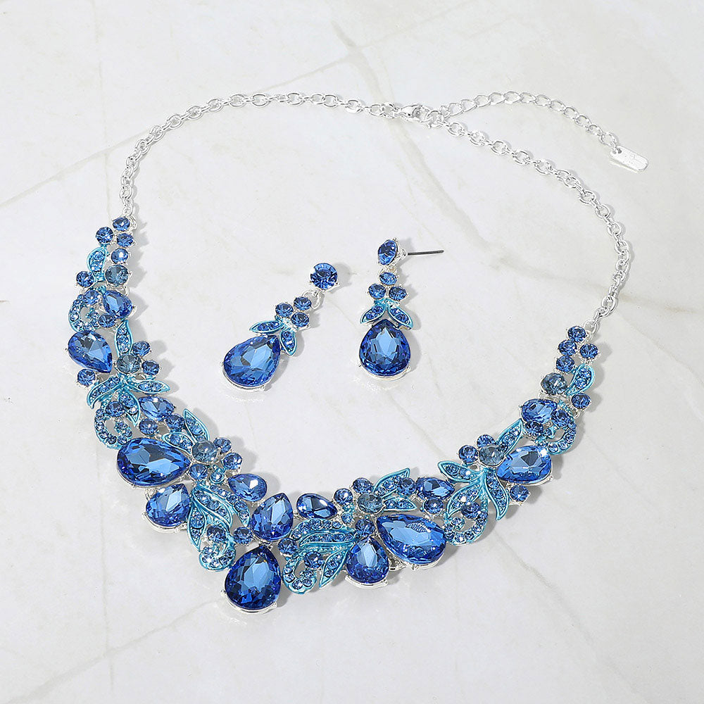 Light sapphire blue teardrop floral statement necklace set on silver displayed on white background
