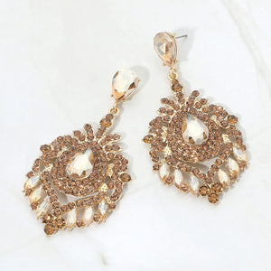 Champagne Gold Stone crystal teardrop chandelier statement pageant earrings on gold with an ornate layered crystal design, displayed on a white background.